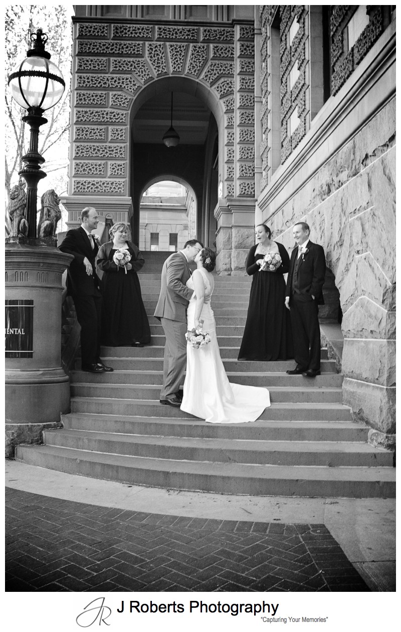 Bridal couple kissing on the steps of the InterContinental Hotel Sydney - sydney wedding photography